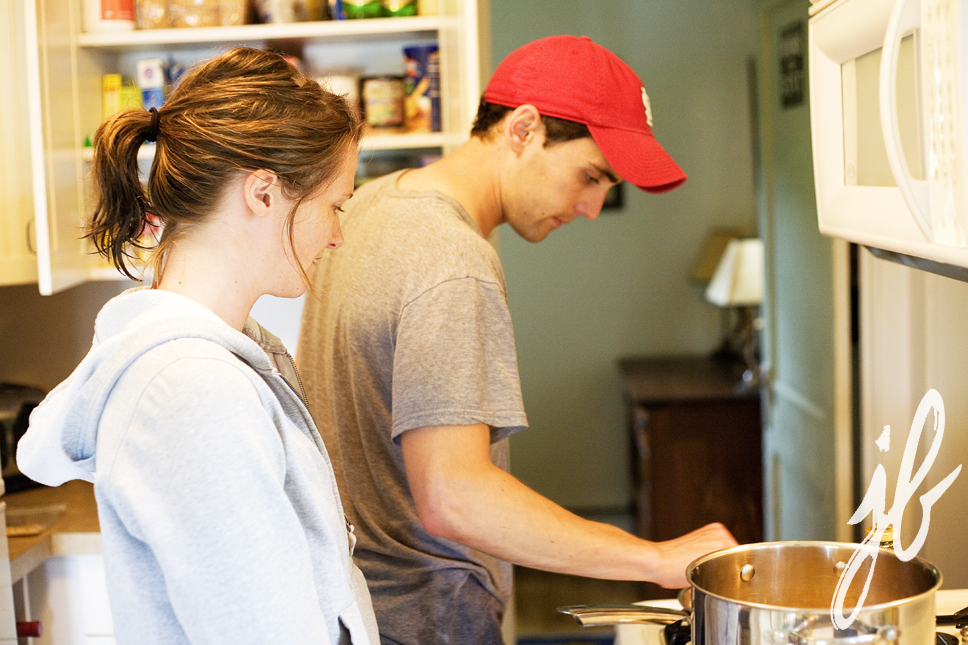 young couple prepares dinner in kitchen at lake house