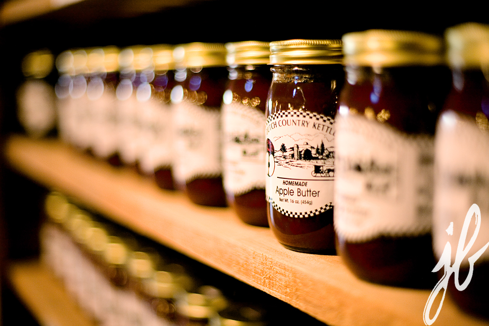 close up of apple butter lined up on shelves