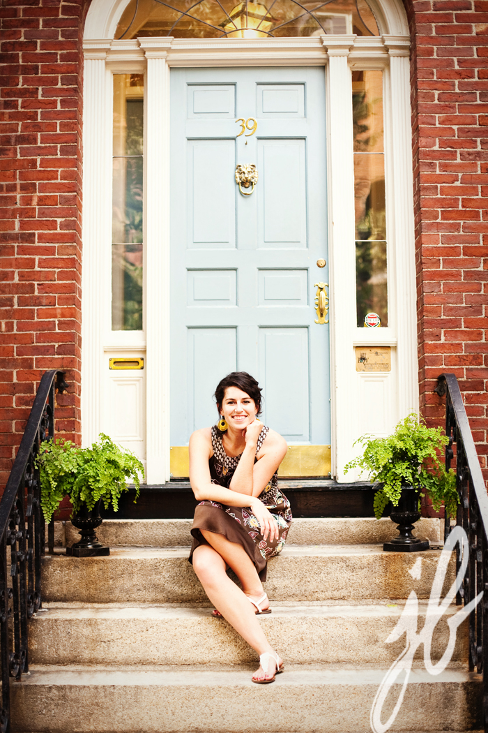 brunette woman posing infront of a light blue door in boston